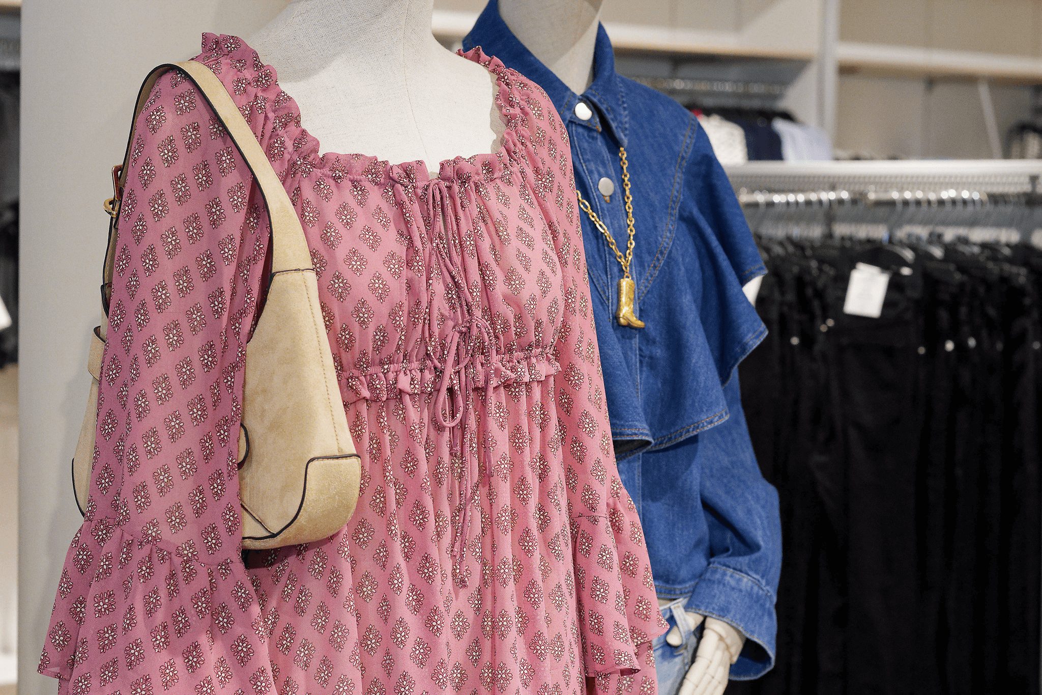 Pink ruffle dress with denim jacket, two mannequins