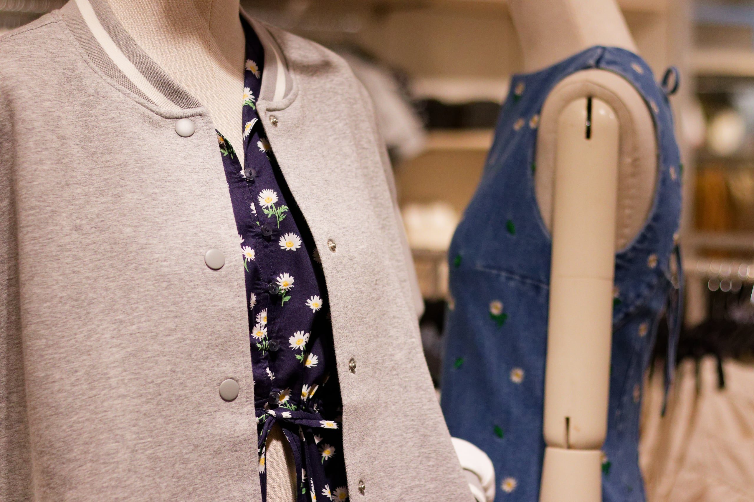 Divided mannequins, grey bomber and daisy print denim