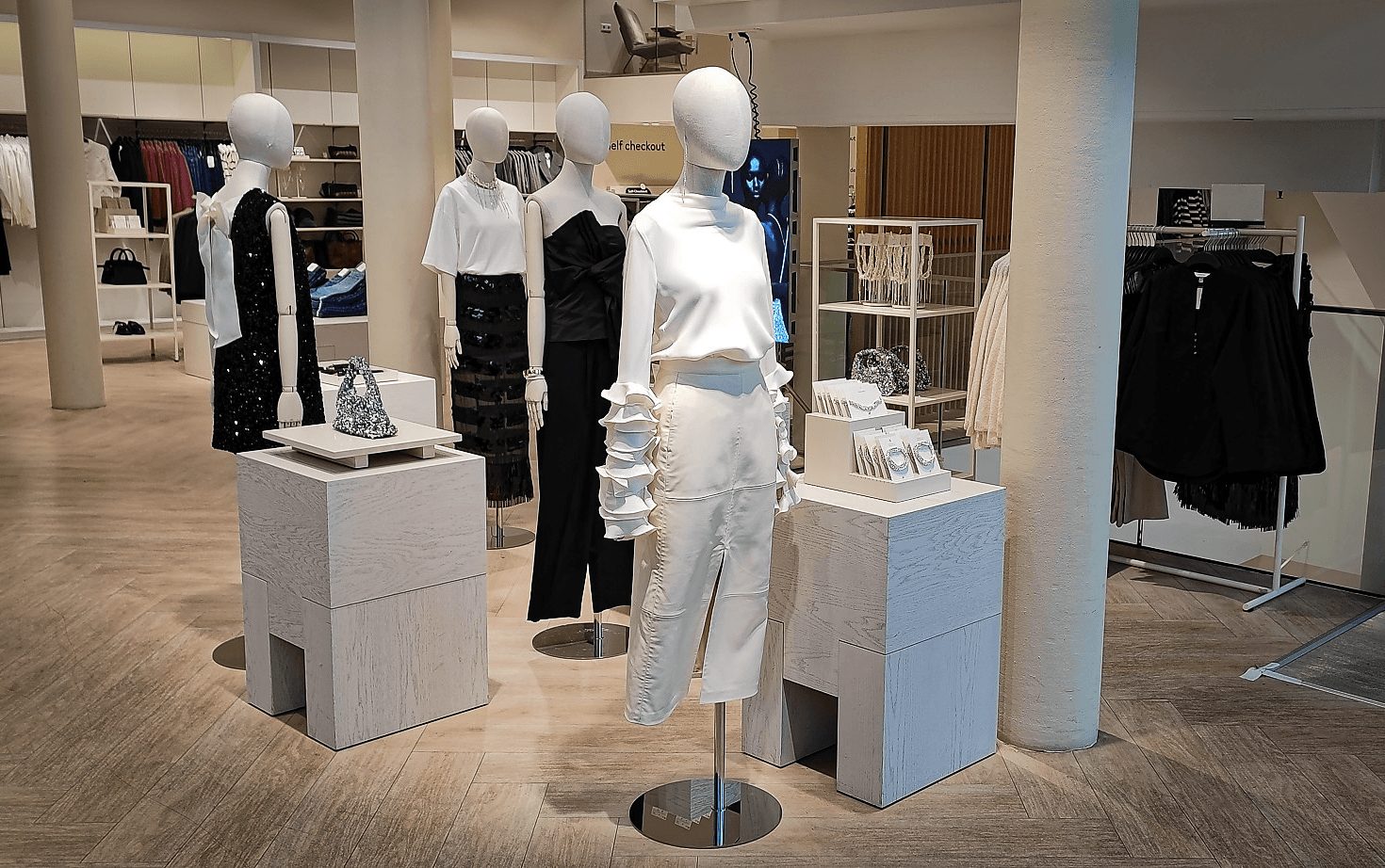 Noir Soirée four-mannequin grouping, evening floor