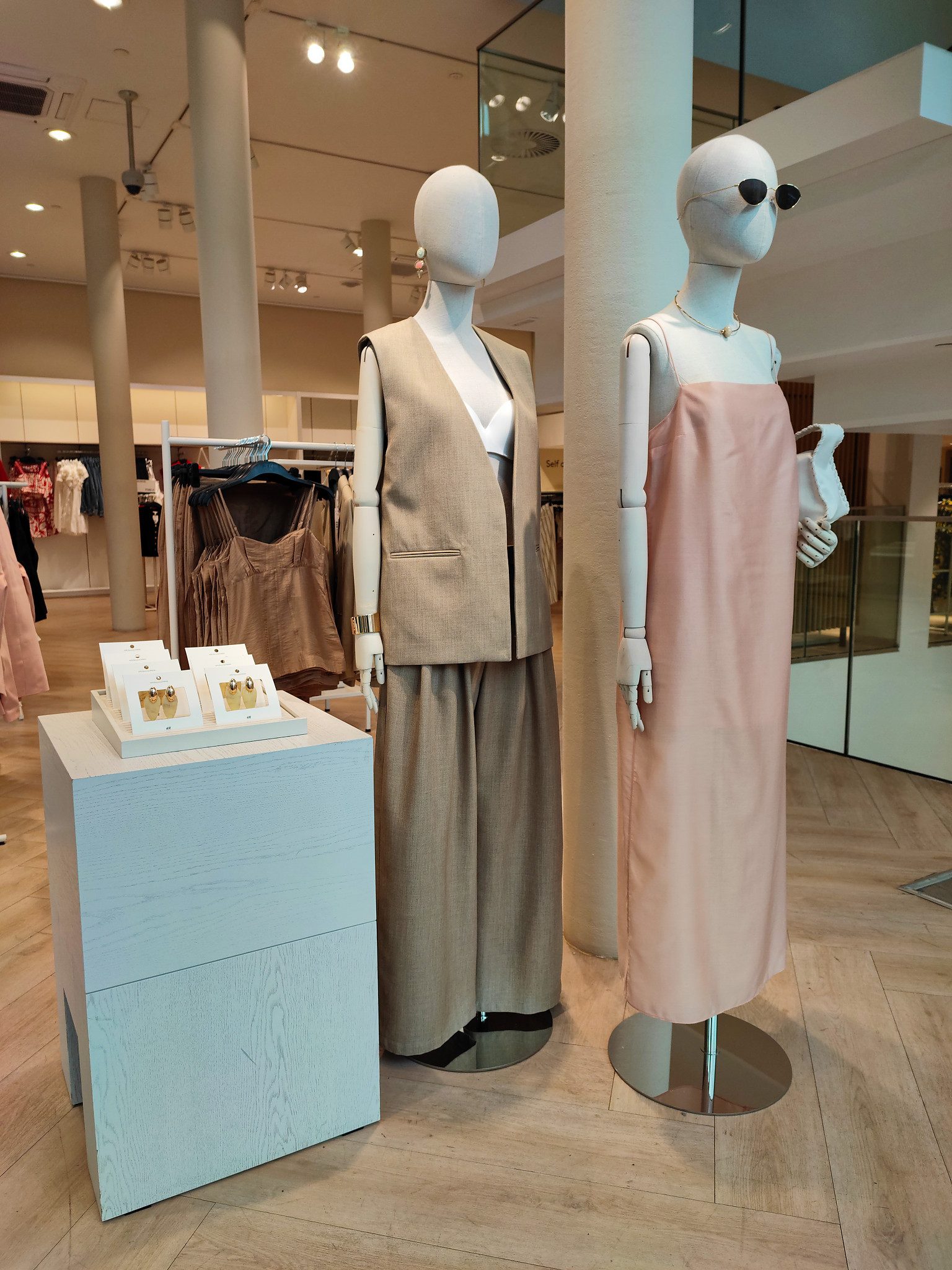 Soft register two mannequins, beige vest and pink dress