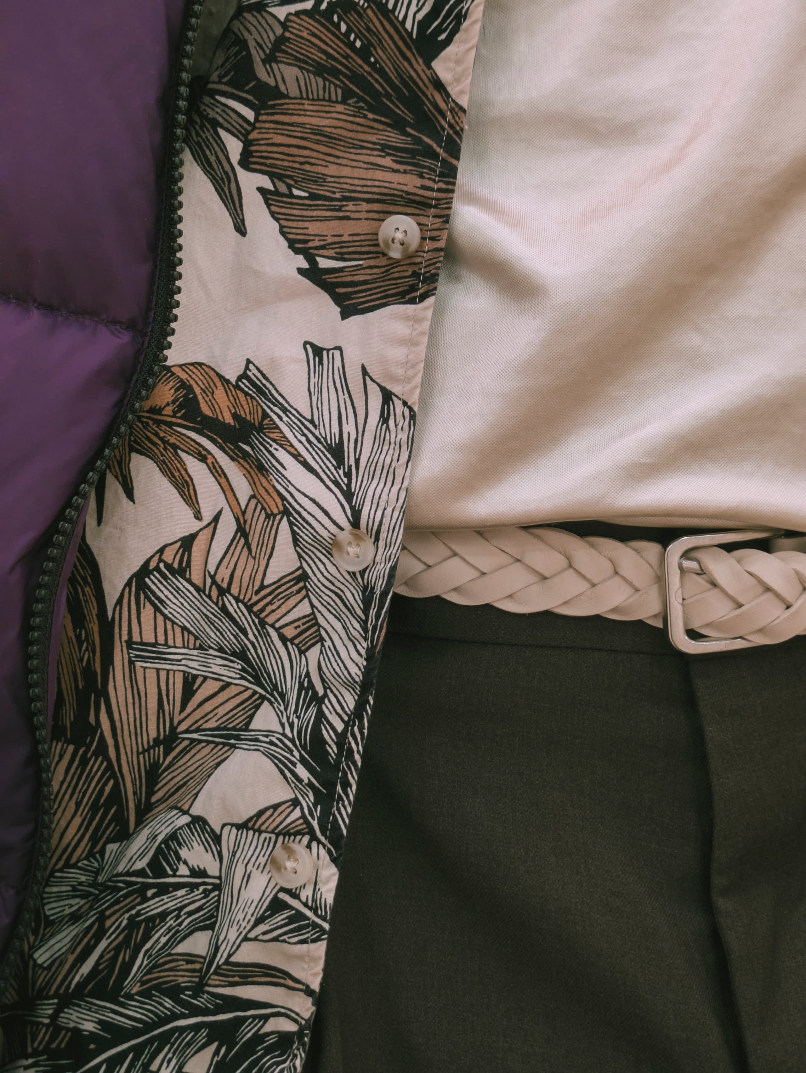 Palm-print vest and braided belt detail